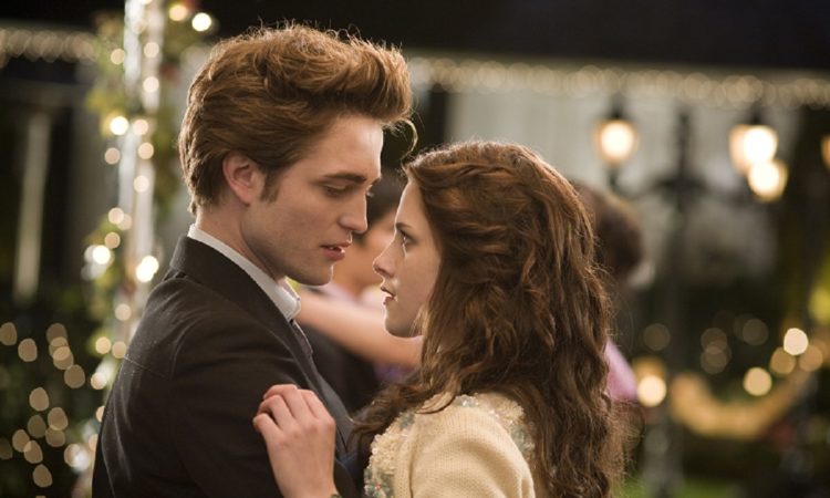 Edward and Bella embrace while dancing at a prom.